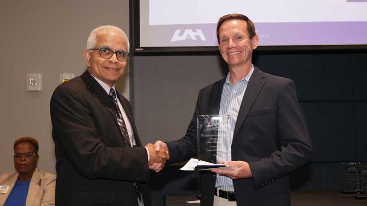 Dr. Shankar Mahalingam, left, dean, College of Engineering, presents the Outstanding Faculty Award to Dr. Thomas Morris.
