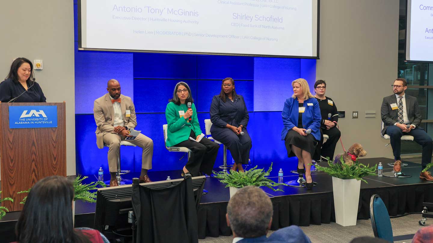 Panelists from the College of Nursing at The University of Alabama in Huntsville and their community partners in the college’s new Neighborhood Nursing initiative discuss the program during SHINE 2025, the second annual Symposium for Health Innovation and Neighborhood Engagement, on the UAH campus. From left, they are Dr. Helen Lien, Nursing senior development officer; Antonio McGinnis, executive director, Huntsville Housing Authority; Dr. Azita Amiri, Nursing associate dean of research; Madison County Commissioner Violet Edwards; Shirley Schofield, CEO, Food Bank of North Alabama; Dr. Melissa Foster, Nursing clinical assistant professor, and Morgan Dennis, vice president of the Cardiovascular Service Line and the Heart Center at Huntsville Hospital Health System.