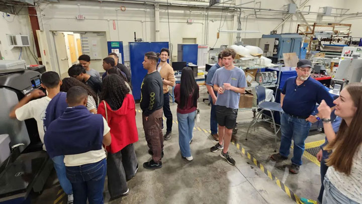 INTEC Team Apolo 27 from the Dominican Republic tours UAH rover shop and assembly areas in Olin B. King Technology Hall on the UAH campus.
