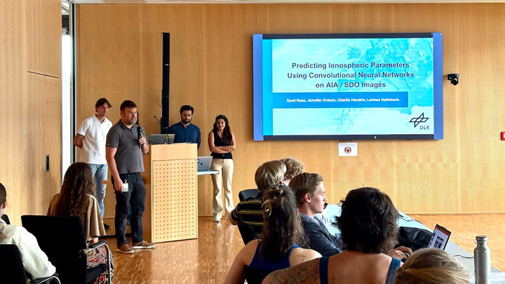 A presentation in a conference room featuring a slide on predicting ionospheric parameters using neural networks, with an audience engaged.