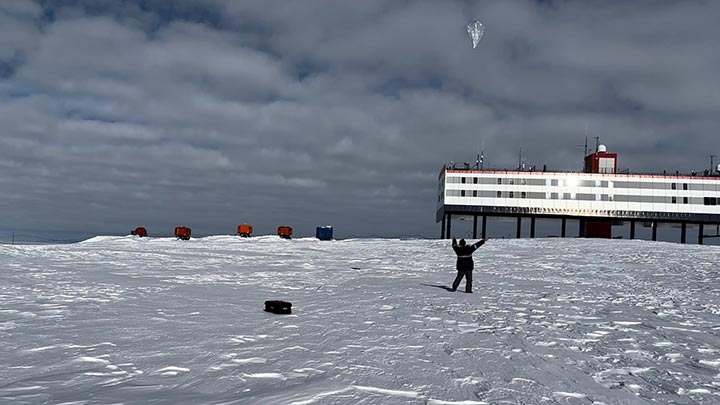 Todd McKinney launches an aerial balloon in snowy Antartica