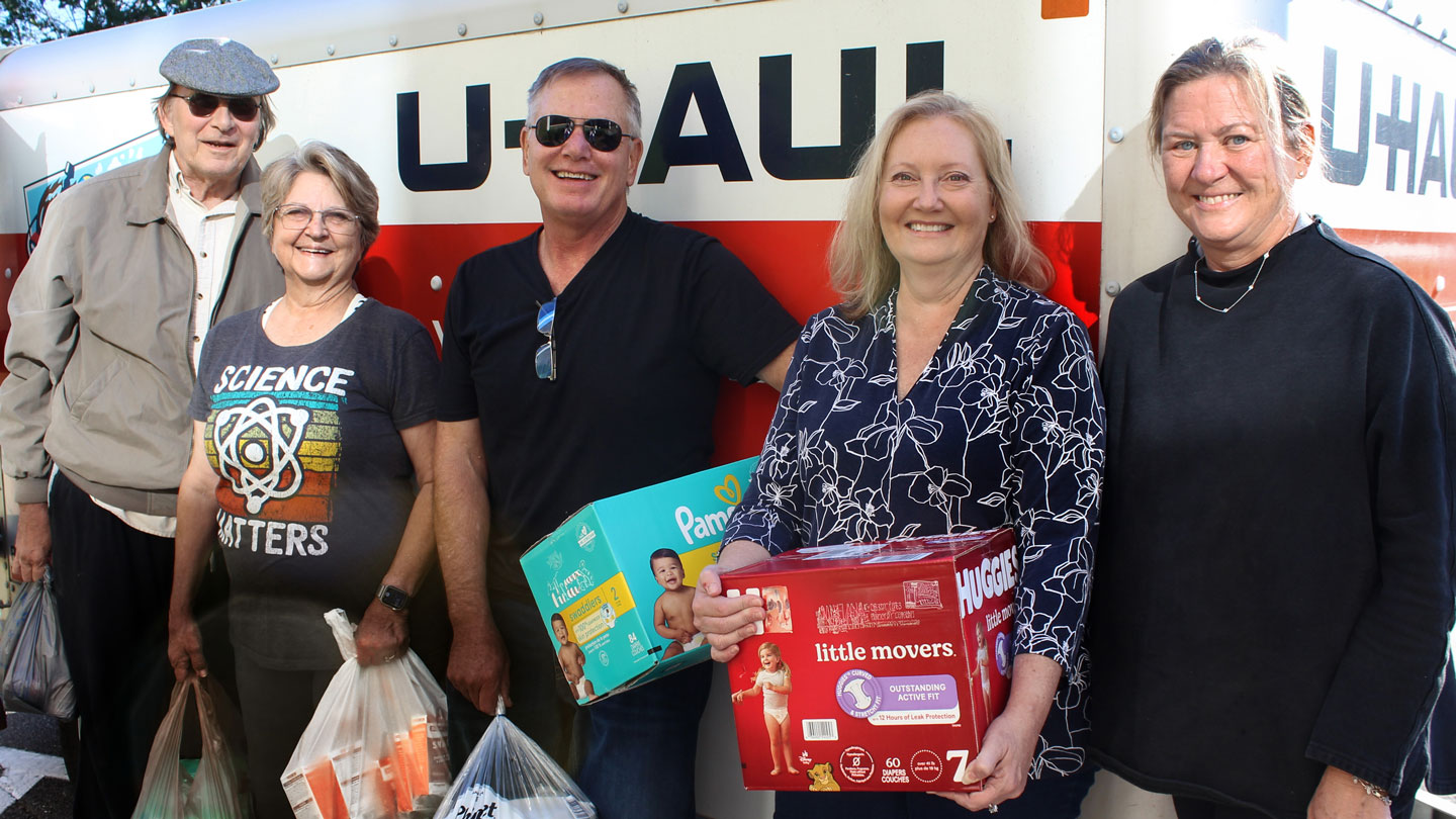 Loading up donations from The University of Alabama in Huntsville left to right, Dan Rochowiak and Debra Moriarity, both retired UAH professors; Bob Michel; UAH alumna Tolli Grisham, and Tammy Eskridge, senior planned giving officer, UAH Foundation.