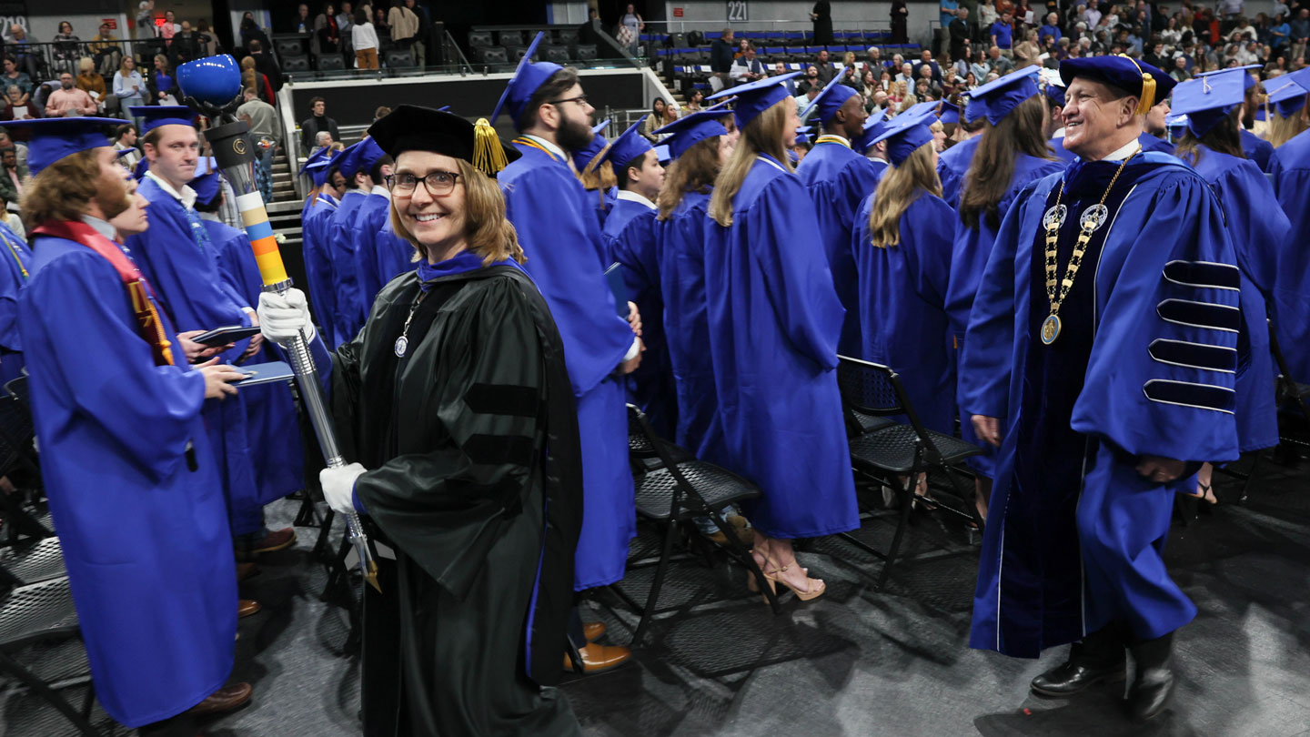 Dr. Terri Johnson, assistant dean of undergraduate affairs, College of Science, Carrying the ceremonial mace at the fall 2024 commencement for The University of Alabama in Huntsville followed by UAH President Dr. Charles Karr.