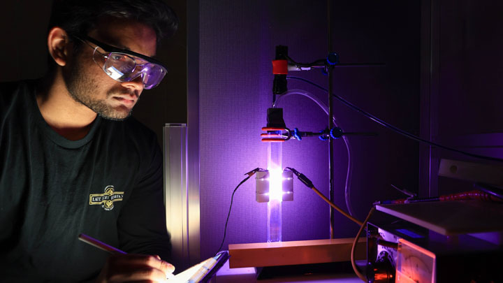 A man wearing goggles and using a tablet