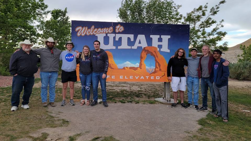 group photo in front of Utah sign