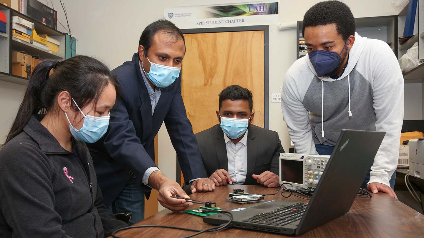 Dr. Biswajit Ray and students working in a lab