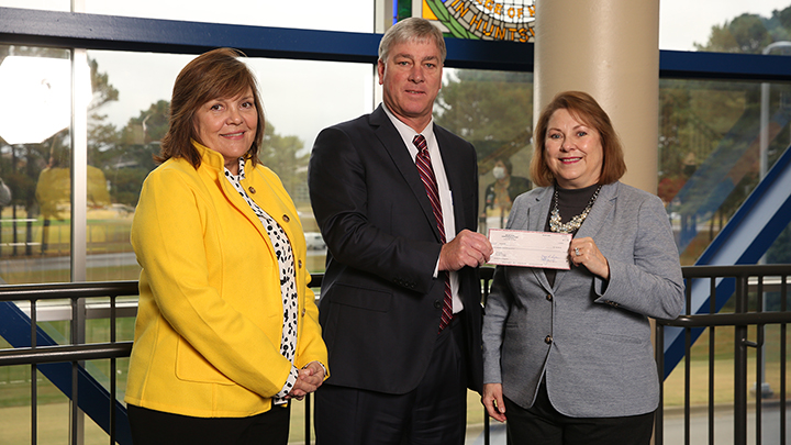 Ken Watson, Bryant Bank president, presents a check to Dr. Amy Lanz and Dr. Karen Frith of UAH College of Nursing.