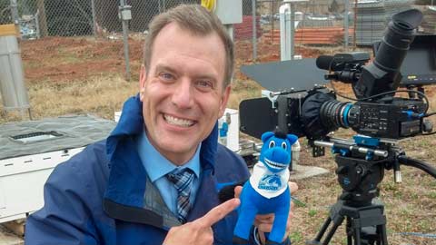 Mike Bettes takes a break with Charger Blue during 2014 Weather Channel coverage on campus.