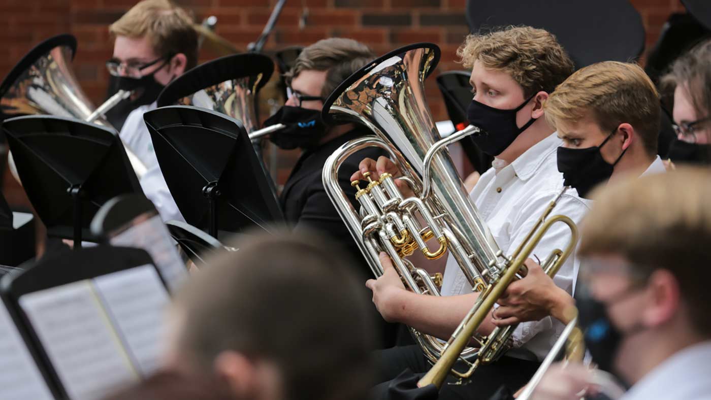 Students playing instruments on the lawn at UAH.