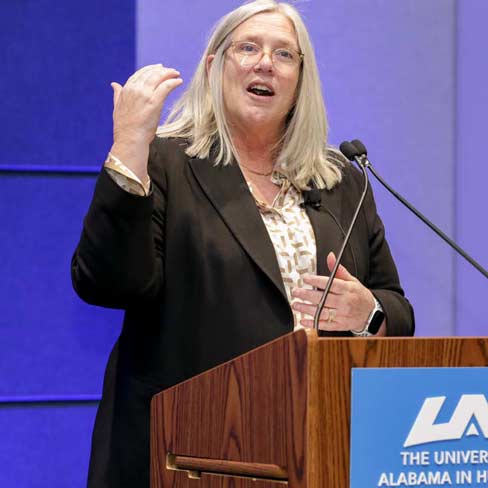 Susan Gordon speaking at a podium at UAH