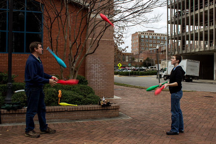 picture of two people juggling