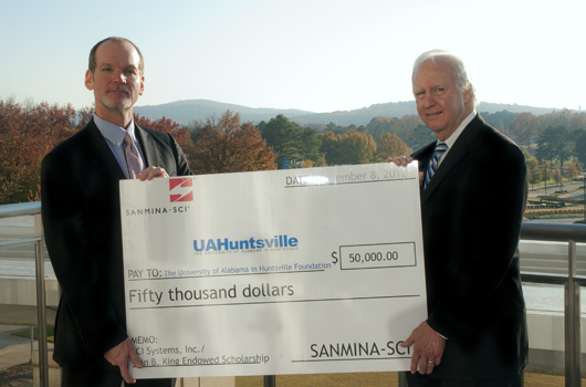 Mike Underwood, President of Sanmina-SCI Defense and Aerospace Systems Division, presents a $50,000 check to UAHuntsville President Bob Altenkirch in honor of SCI Systems Founder and former University of Alabama Board of Trustee member Olin King.