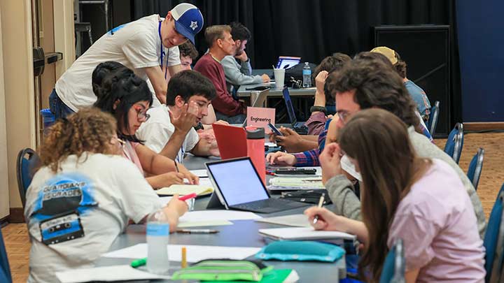 Students & Tutors around a table studying at the SSC.