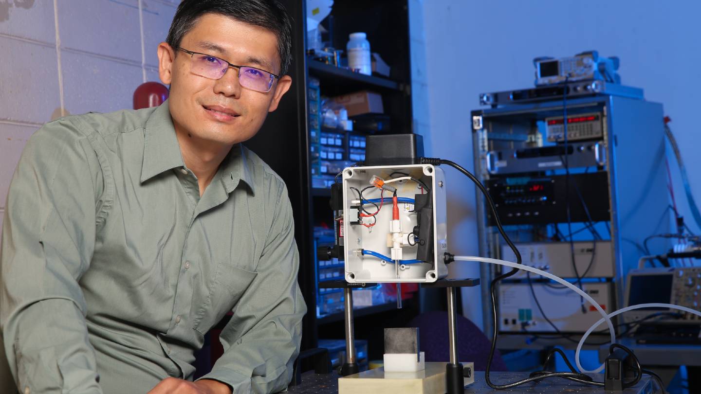 Dr. Gabe Xu sitting in a research lab.