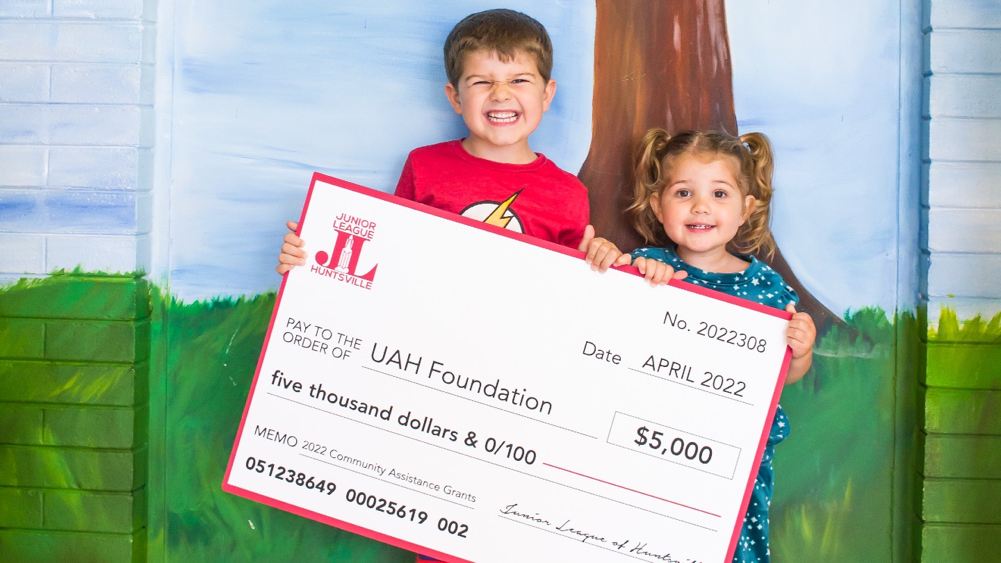 pre-k students shown holding a check for $5000 for the UAH Early Learning Center