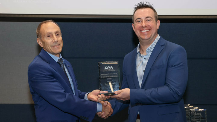 Provost Dave Puleo presents Research and Creative Activity Undergraduate Mentor Award to Dr. Ryan Conners