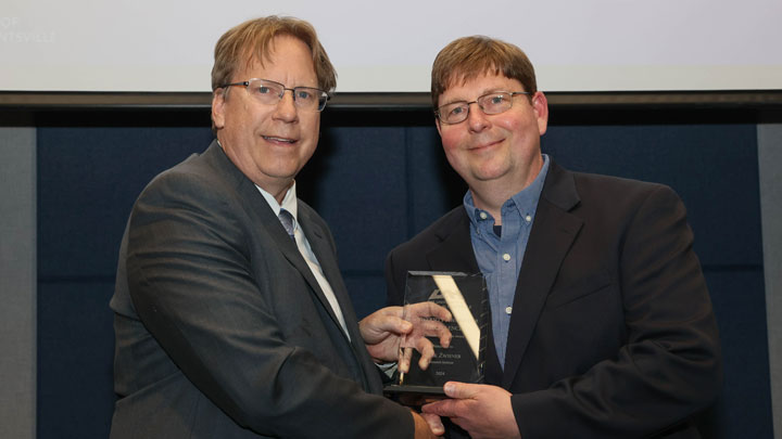 Dr. Robert Lindquist, vice president for research and economic development, presents University Researcher of the Year Award to Mark Zwiener