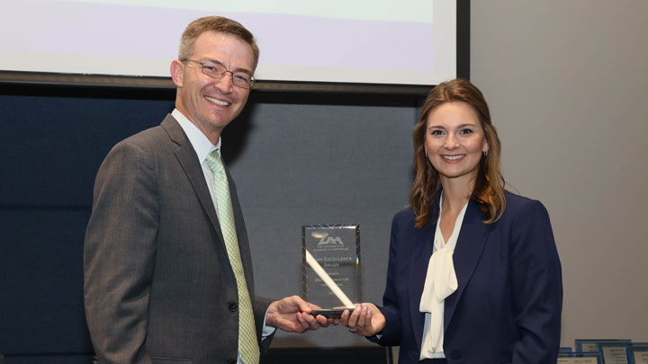 Brad Cooper, assistant vice president, finance and business services/controller, presents Staff Excellence Award to Drew Yarbrough