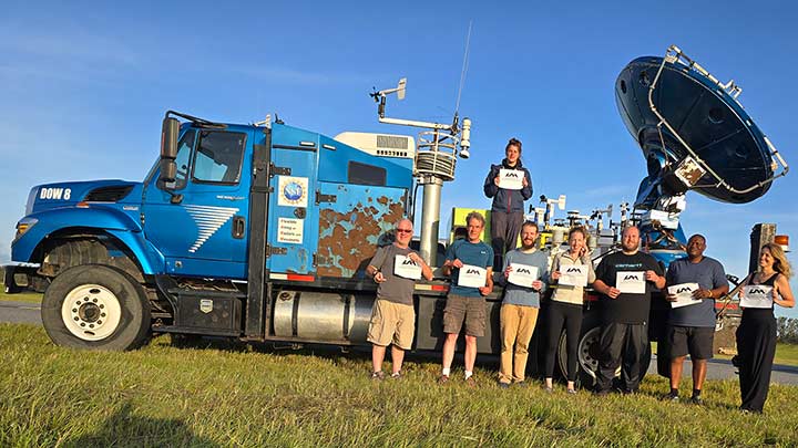 Members of the FARM team standing near the DOW truck.