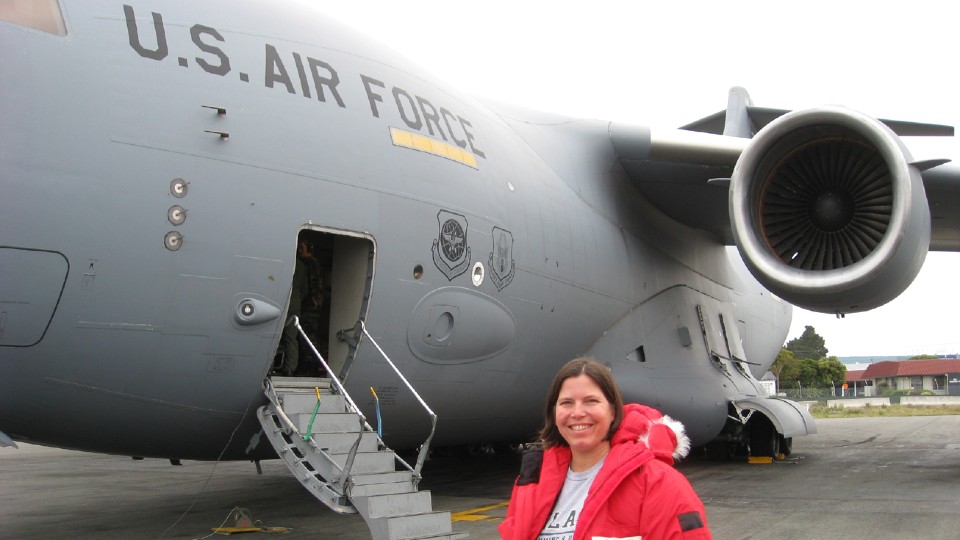 Tia standing in front of the aircraft