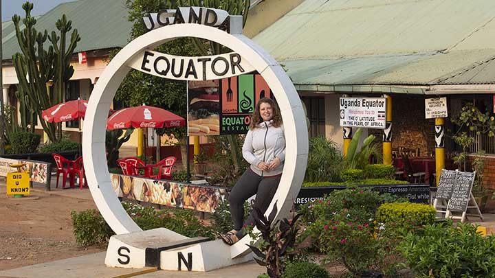 Emily Gothro in Uganda under the equator sculpture ?>