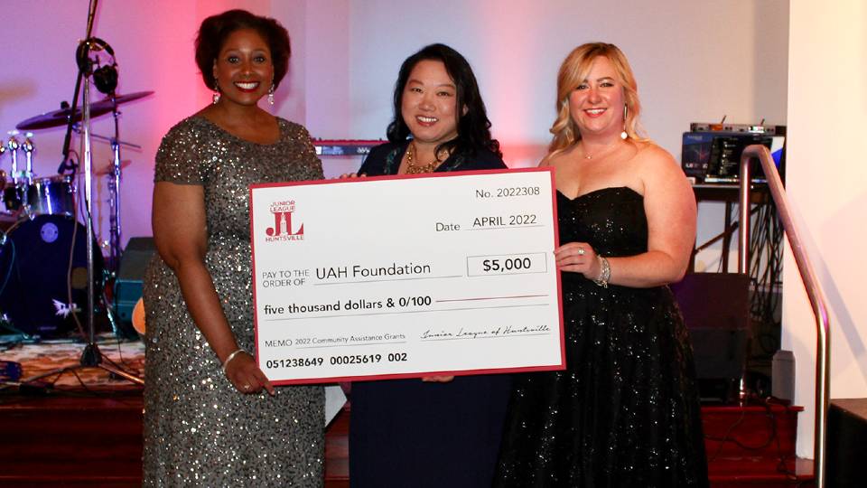 Kristina, Helen, and Kaitlynn are shown holding the $5000 check for UAH Early Learning Center