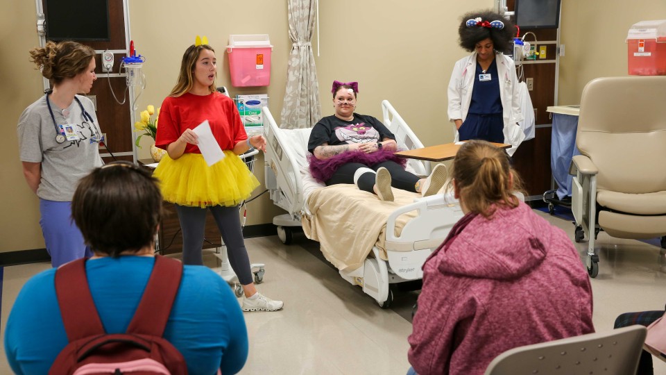 students and participants in a mock hospital setting