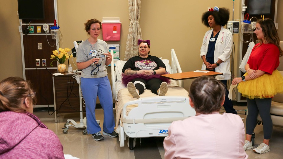 students and participants in a mock hospital setting