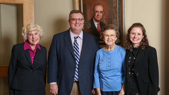 Dr. Christine Curtis,  David Moore, Elisabeth Whitten, and Mallie Hale pose in front of a painting of Louis Salmon ?>