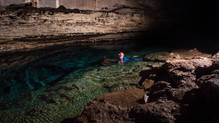 man snorkeling in a cave