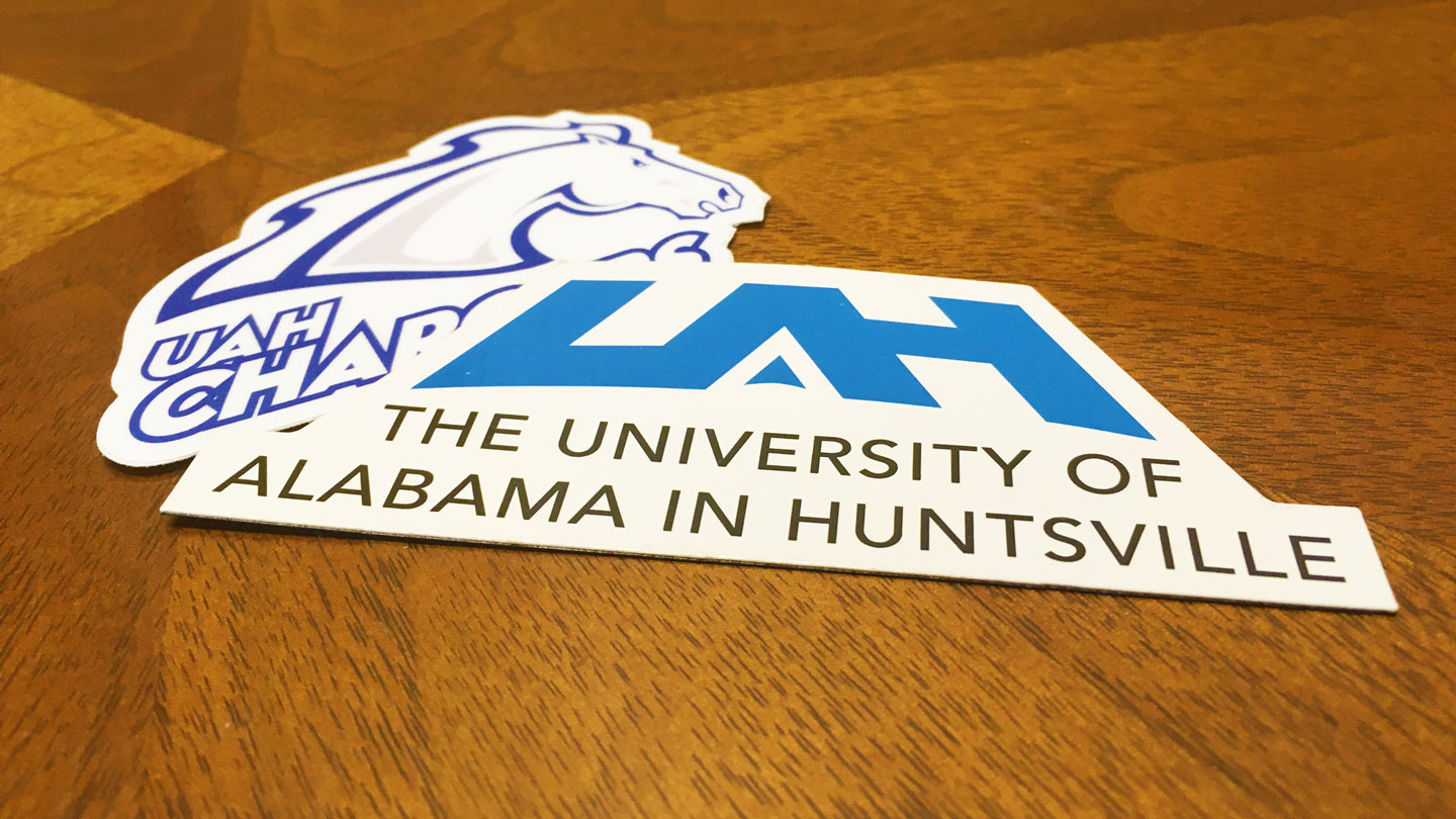 Logo stickers for U A H and Charger Athletics.