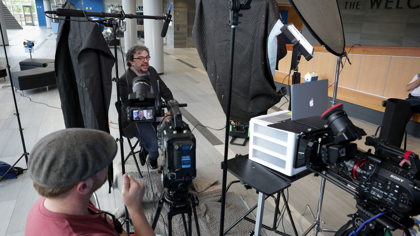 A film crew prepares to interview U A H biology professor Jerome Baudry.