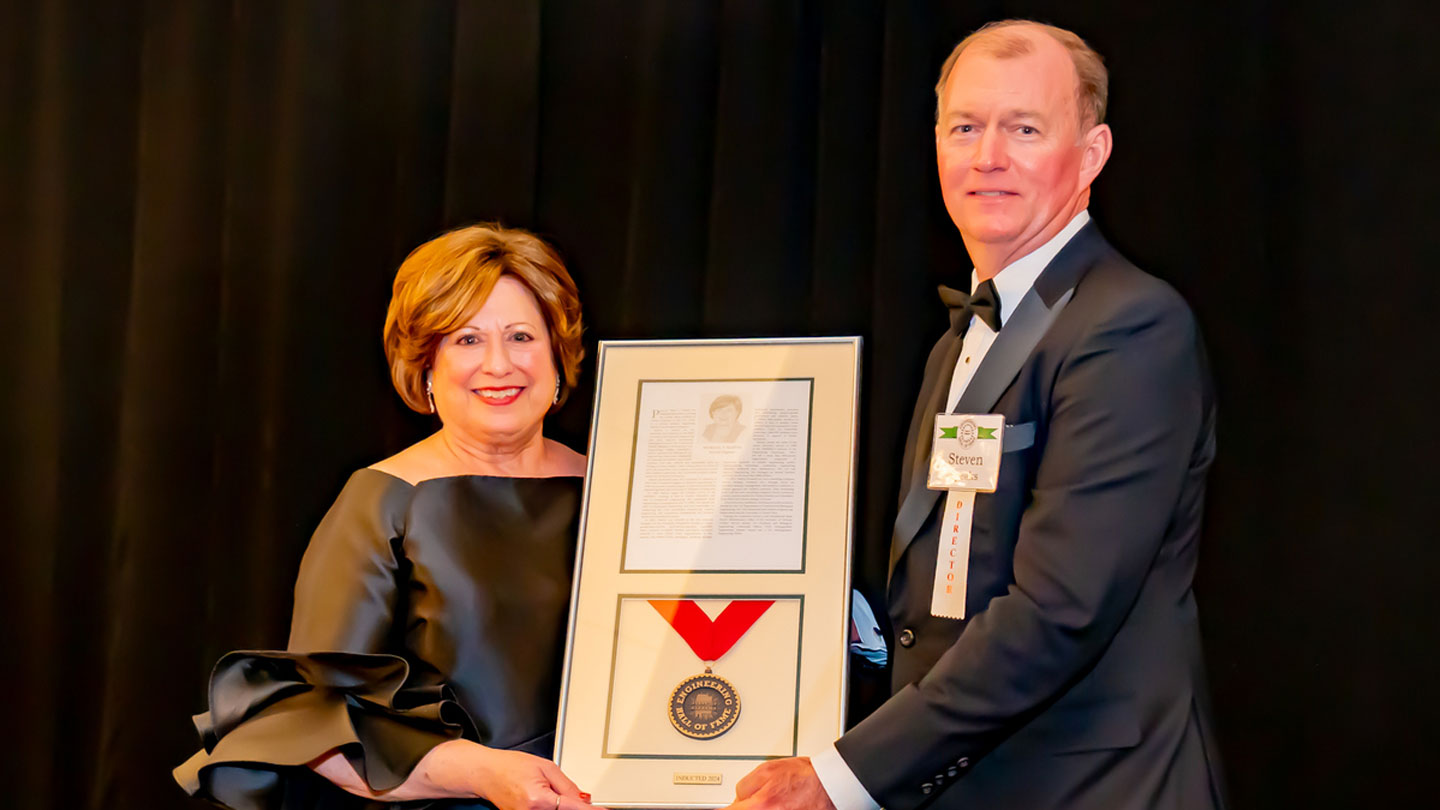 Patricia Patti Martin receiving an award from AEHOF Chairman Steven Speaks