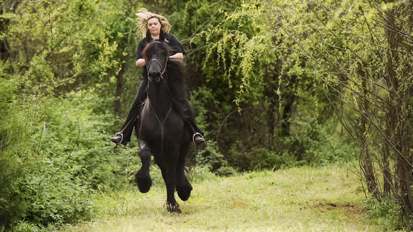 Hannah Padgett riding a black horse