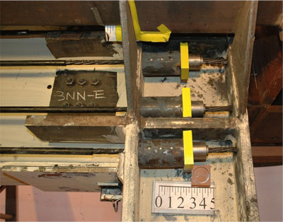 The 4-inch annealed steel tube with wooden disks, or fuse, is designed to be crushed before the post-tensioning elements reach their fracture strength.