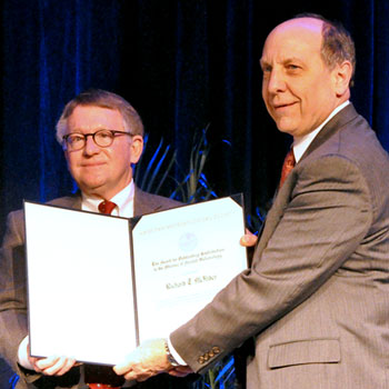 Dick McNider (left), a distinguished professor emeritus in mathematical sciences at The University of Alabama in Huntsville, was honored earlier this month by the American Meteorological Society for his contributions to applied meteorology.