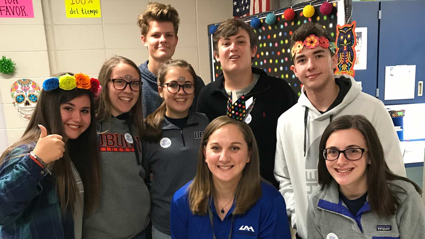 UAH student Vicky Prosser (center, kneeling) pictured with her Spanish students at Buckhorn High School.