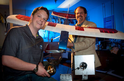 Mechanical Engineering student Josiah Thomas (left), and Dr. D. Brian Landrum, associate professor of Aerospace Engineering at UAH, discuss placement of a solar blind fire sensor on a UAV (unmanned aerial vehicle).