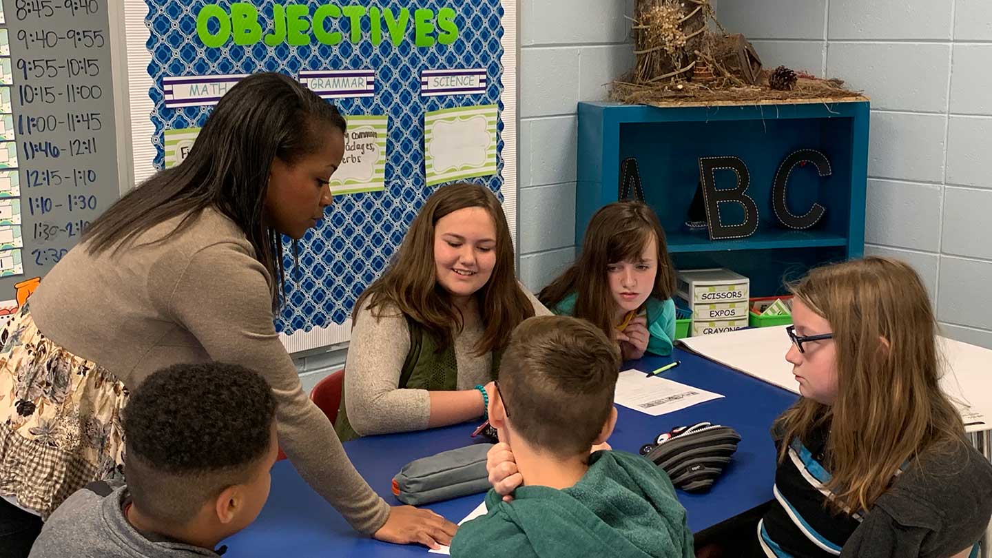 Traneshia Stoudemire standing with her fifth grade students