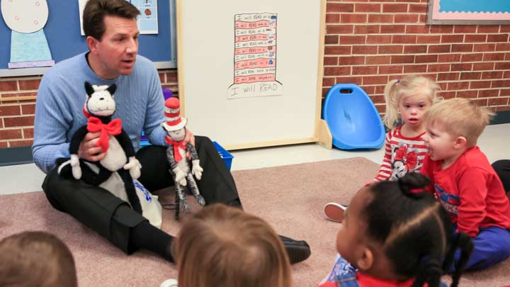 Dr. E. J. Brophy reads Dr. Seuss to students