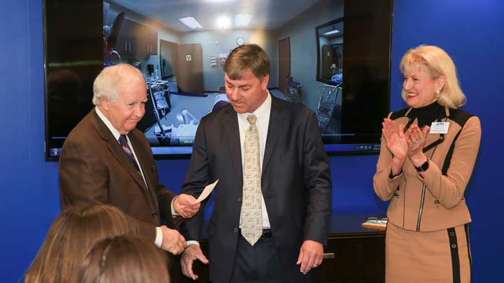 UAH President Robert Altenkirch and Nursing Dean Marsha H. Adams accept a $100,000 check from Ken Watson, President of Bryant Bank. The bank funds the prestigious Excellence in Nursing Scholarship.