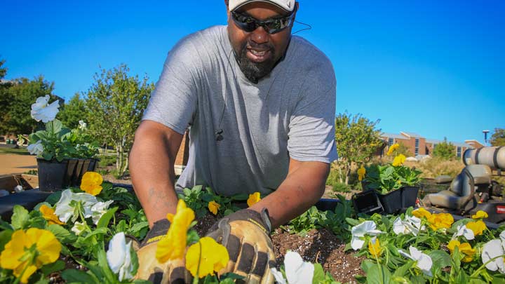 Groundskeeper John McLeod preparing campus for cooler weather.