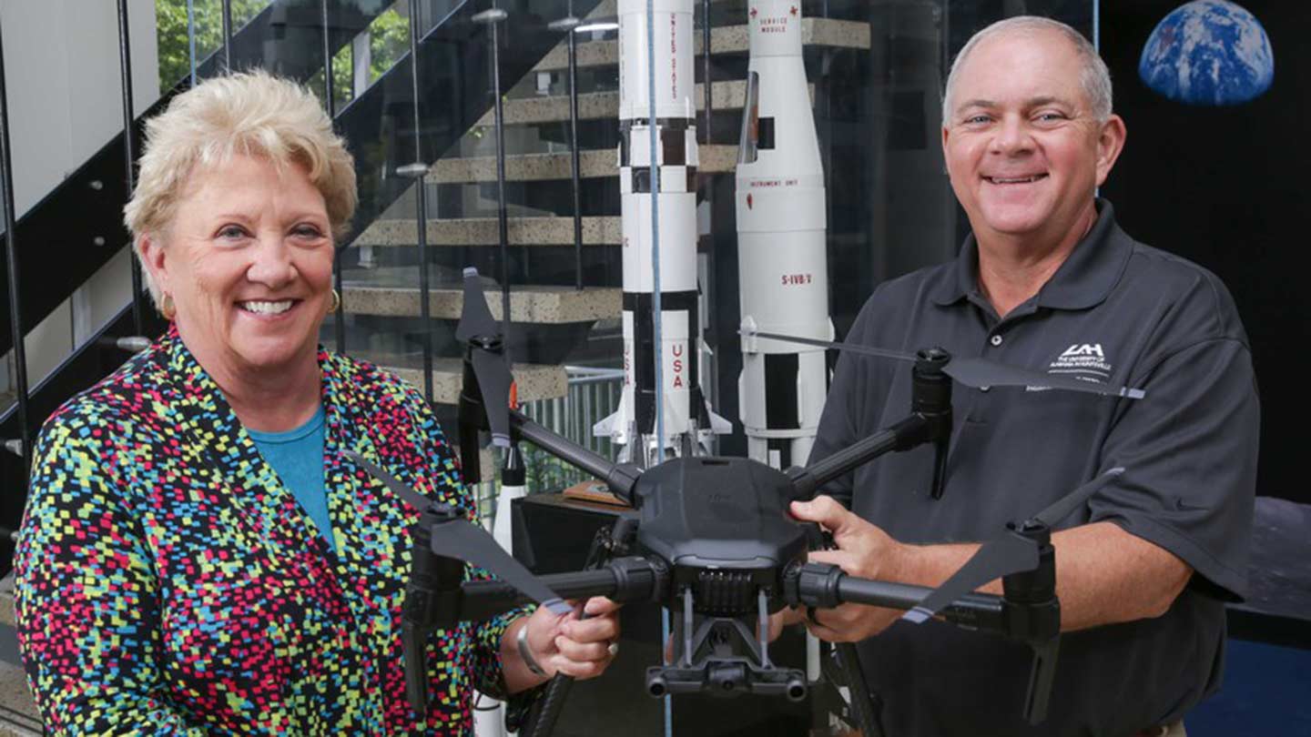 Dr. Virginia “Suzy” Young and Jerry Hendrix holding a drone.