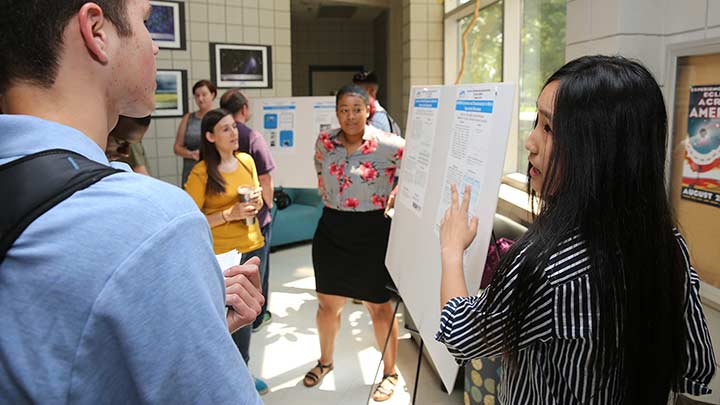 ALSAMP students present their research at a recent event.