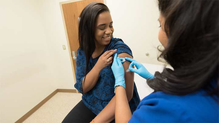 Person getting vaccine in arm. ?>