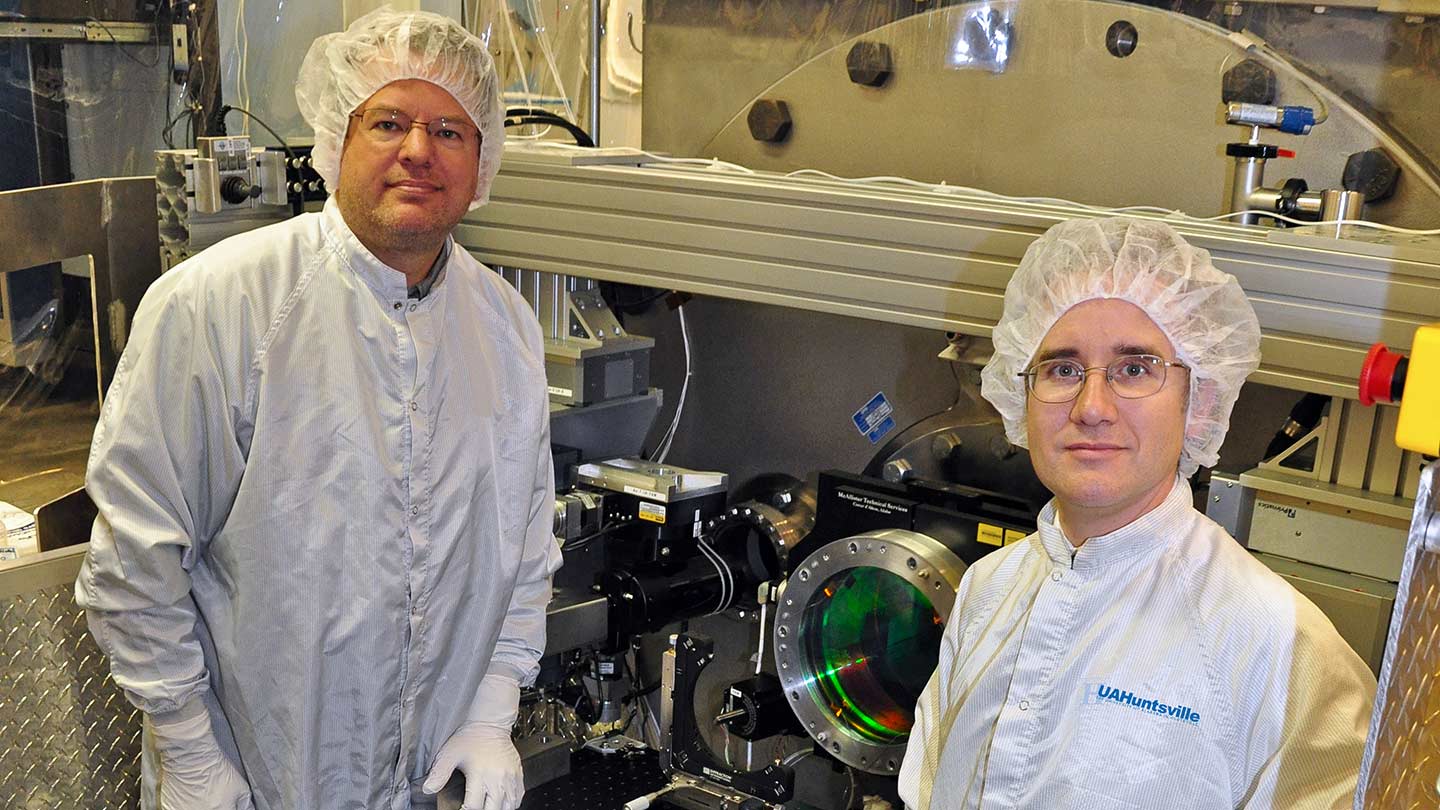 James Hadaway and Patrick Reardon testing equipment in a lab.