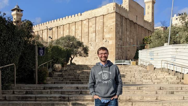 Russel Pope standing on the steps in front of the Cave of the Patriarch ?>