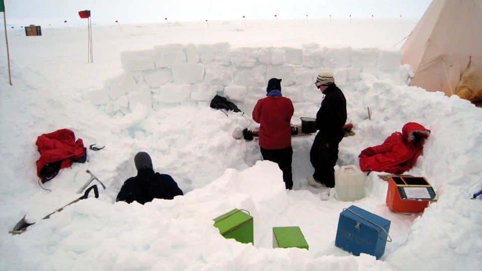 people building a wall made of snow