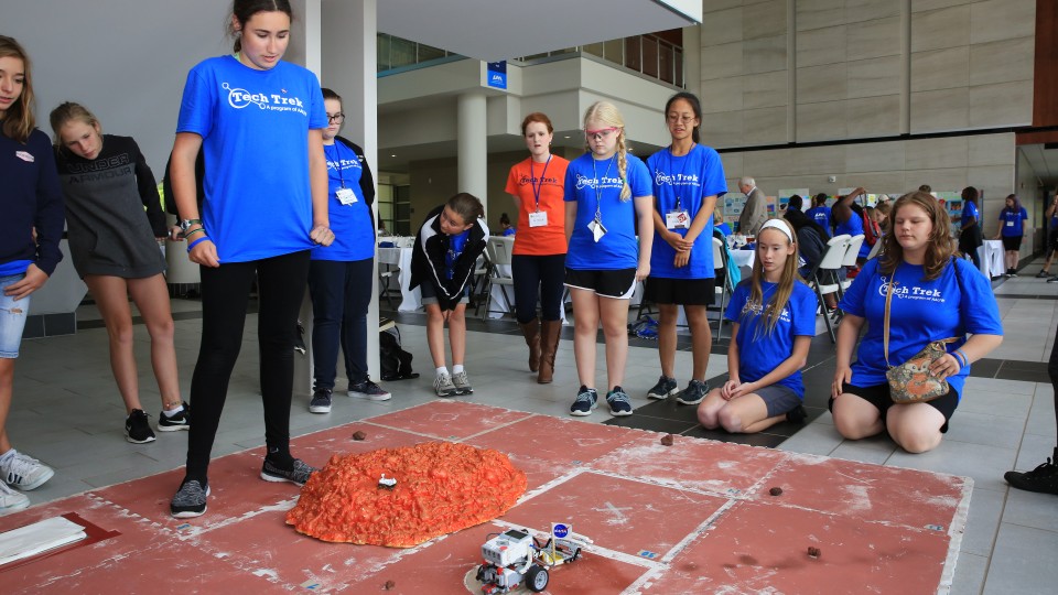 girls observing a robotic experiment