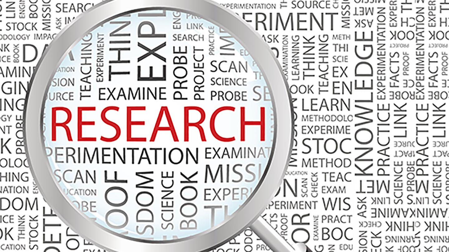 photo of a magnifying glass enlarging the word research